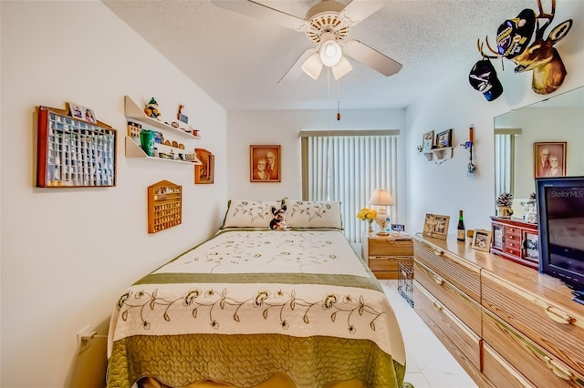 bedroom with a textured ceiling and ceiling fan