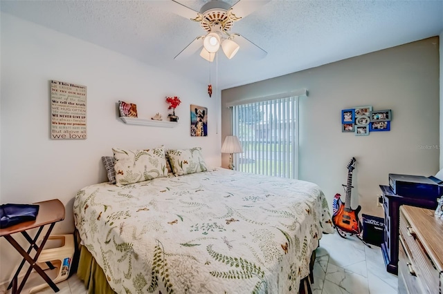 bedroom featuring a textured ceiling and ceiling fan