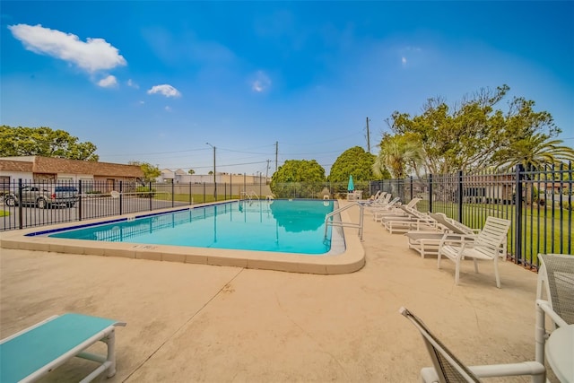 view of swimming pool with a patio