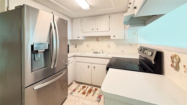 kitchen with tasteful backsplash, light tile patterned flooring, appliances with stainless steel finishes, and sink