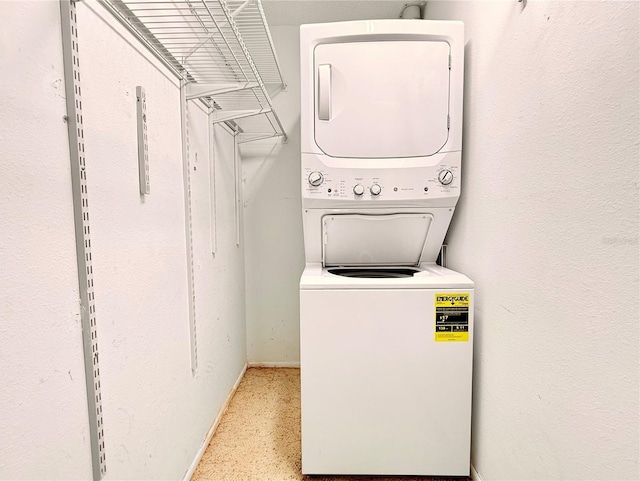 washroom featuring stacked washing maching and dryer