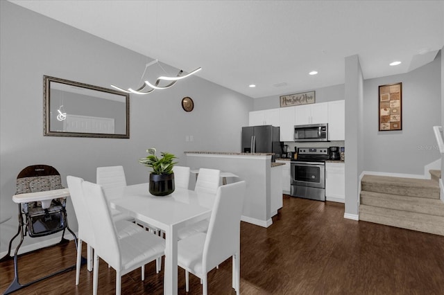 dining space featuring dark hardwood / wood-style flooring