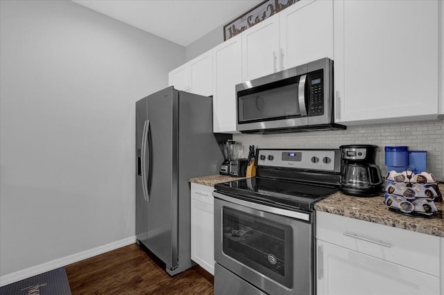 kitchen with white cabinetry, light stone countertops, dark hardwood / wood-style flooring, appliances with stainless steel finishes, and tasteful backsplash