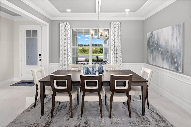 dining room with an inviting chandelier, ornamental molding, and light tile floors