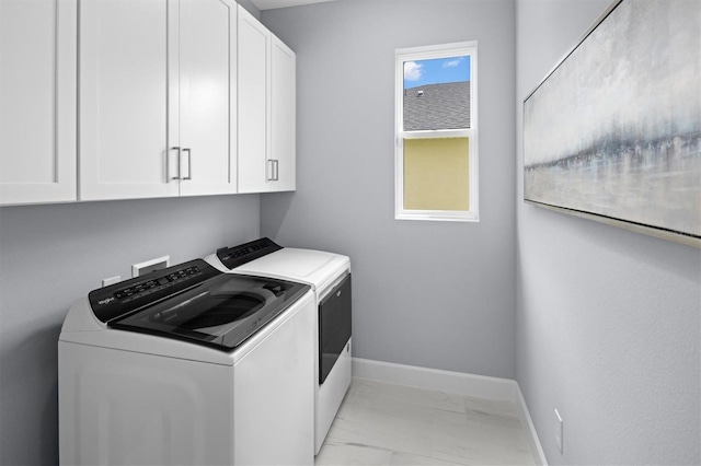 washroom featuring independent washer and dryer, light tile flooring, cabinets, and hookup for a washing machine