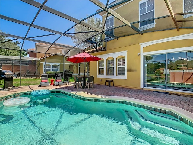 view of pool with a lanai and a patio