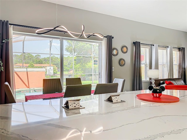 dining room featuring a healthy amount of sunlight and a notable chandelier