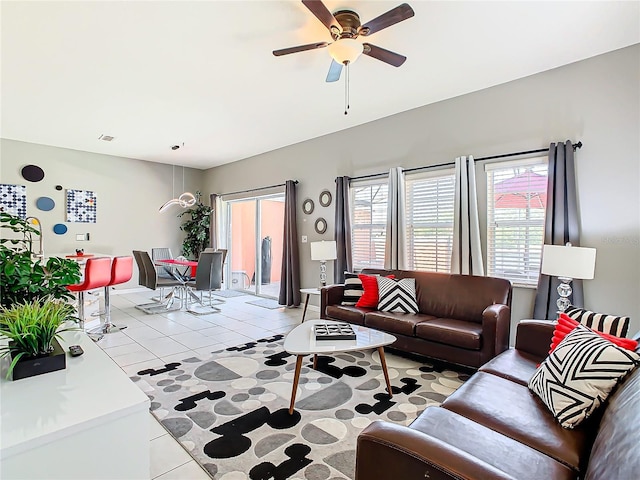 living room with ceiling fan and light tile patterned floors