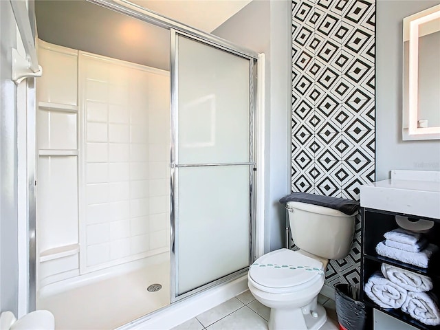 bathroom featuring tile patterned flooring, toilet, and walk in shower