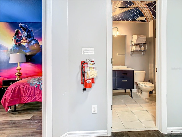 bathroom with tile patterned floors, vanity, and toilet