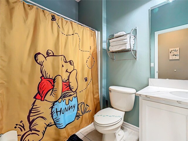 bathroom with tile patterned flooring, vanity, and toilet