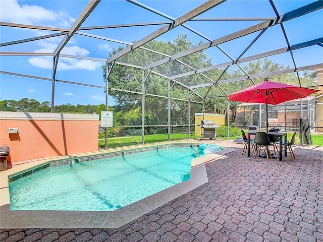 view of pool featuring a lanai, a patio area, and a grill