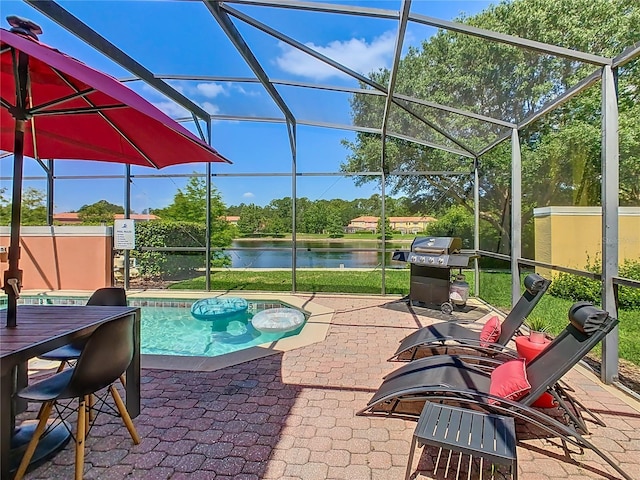 view of swimming pool featuring a grill, a water view, a patio, and glass enclosure