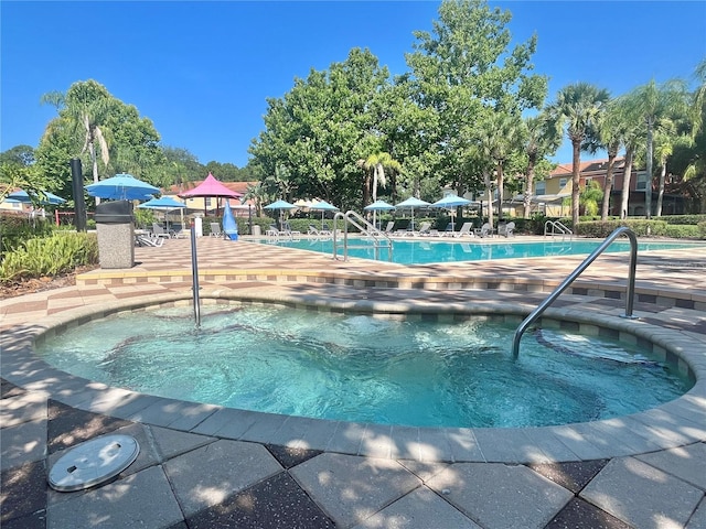 view of pool with a community hot tub and a patio