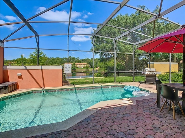 view of pool with a lanai, a patio area, and a water view