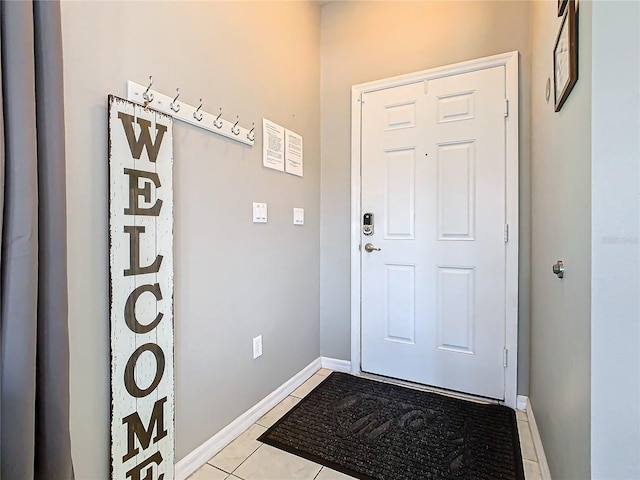 doorway to outside with light tile patterned flooring