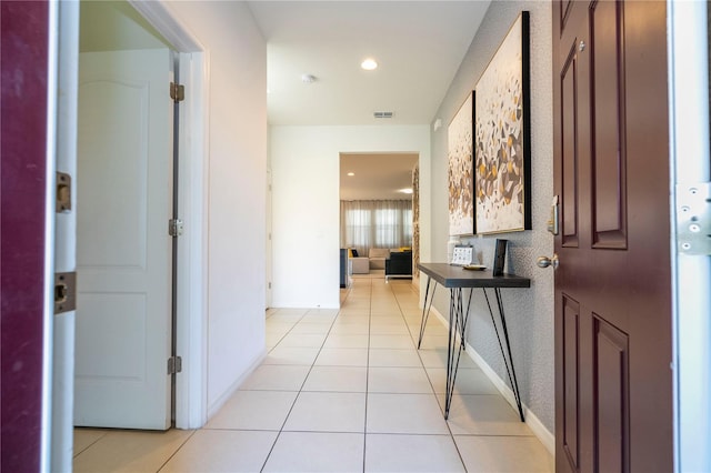 corridor featuring light tile flooring