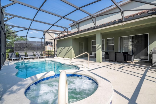 view of swimming pool with a patio area, glass enclosure, and an in ground hot tub