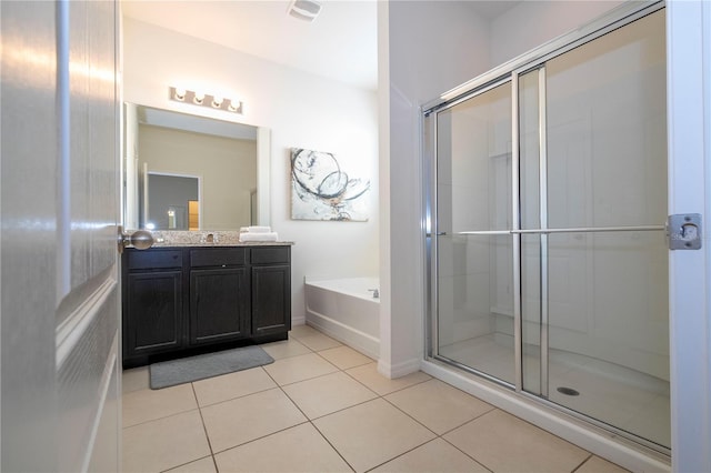 bathroom with independent shower and bath, vanity, and tile flooring