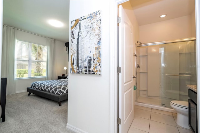 bathroom featuring walk in shower, vanity, toilet, and tile floors