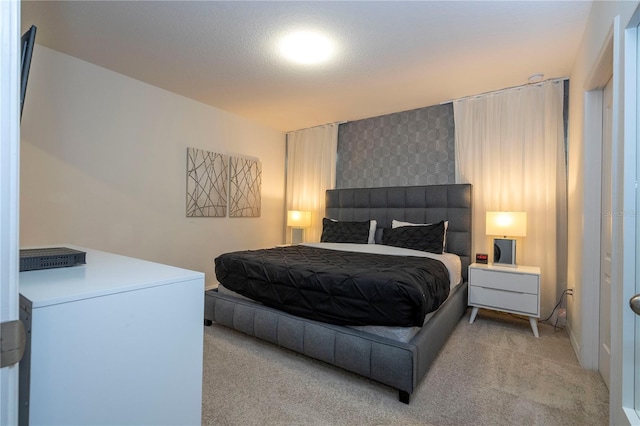 bedroom featuring light colored carpet