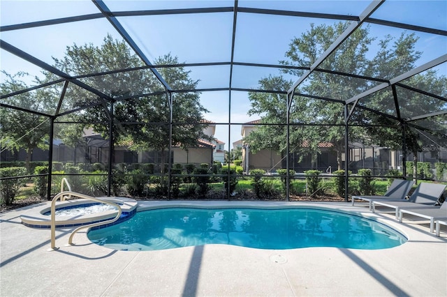 view of swimming pool featuring glass enclosure and a patio area