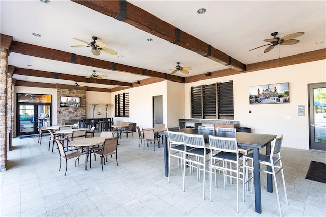 dining space with beamed ceiling, ceiling fan, and light tile floors