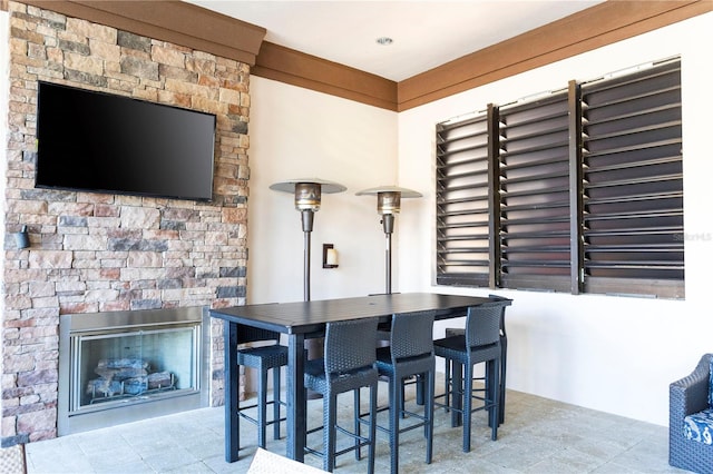 tiled dining space featuring a fireplace