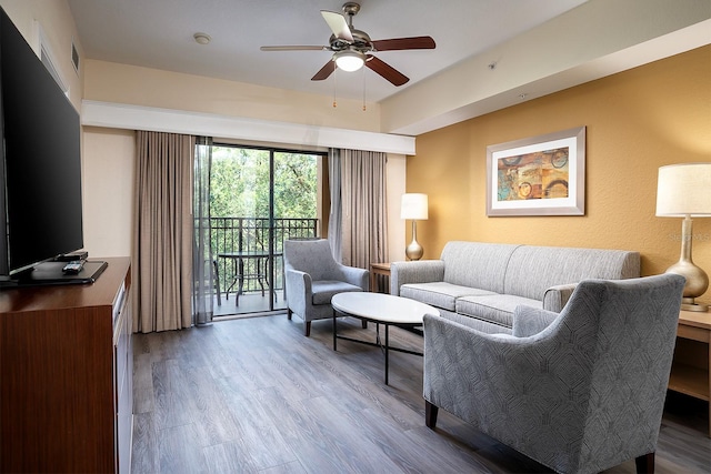 living room with hardwood / wood-style floors and ceiling fan