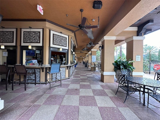 view of patio with ceiling fan and exterior bar