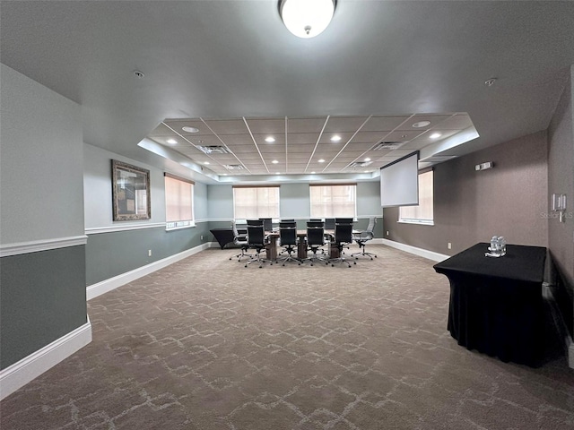 interior space with a tray ceiling and carpet