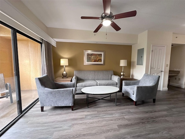 living room with hardwood / wood-style floors, electric panel, plenty of natural light, and ceiling fan