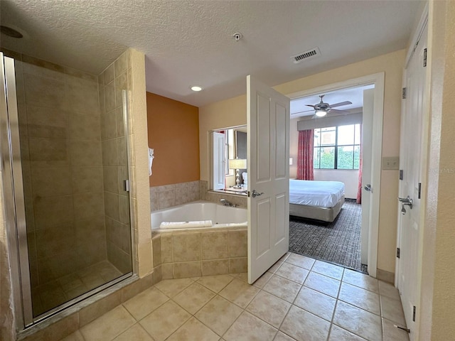 bathroom featuring tile patterned flooring, a textured ceiling, ceiling fan, and plus walk in shower