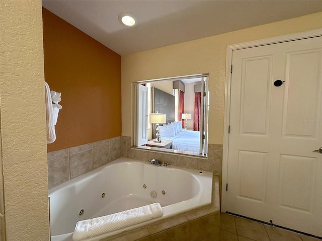 bathroom featuring tile patterned floors and a relaxing tiled tub