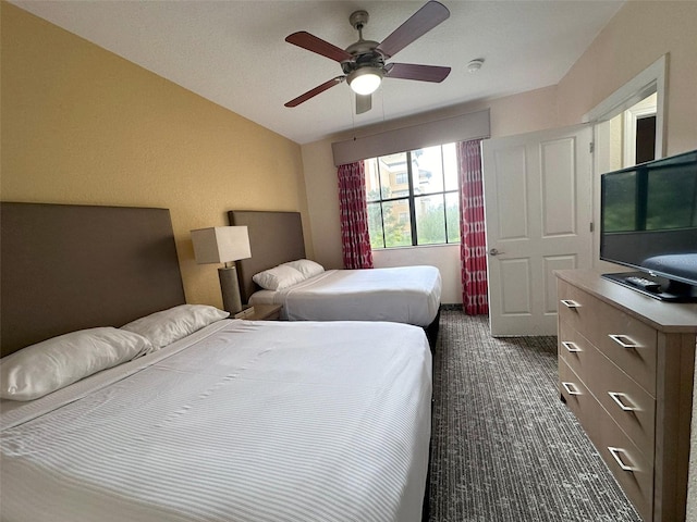 carpeted bedroom with vaulted ceiling and ceiling fan