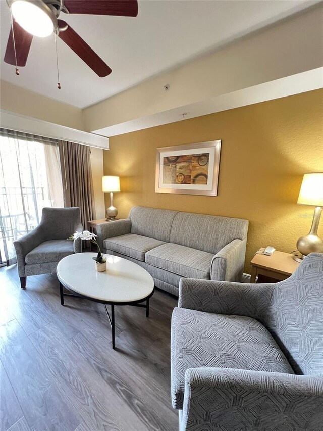 living room featuring hardwood / wood-style flooring and ceiling fan