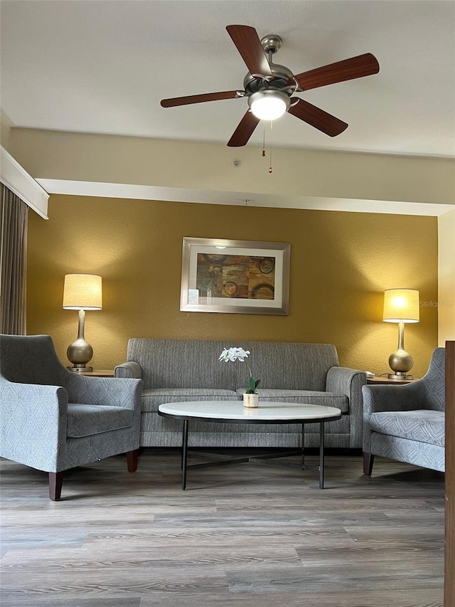 living room with ceiling fan and wood-type flooring