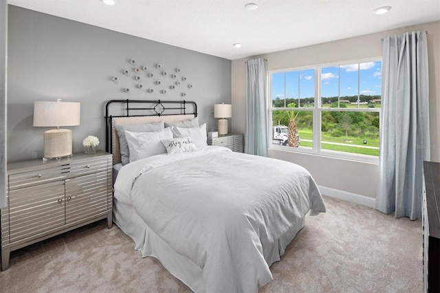 bedroom with recessed lighting, light colored carpet, and baseboards