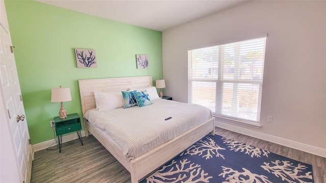 bedroom featuring hardwood / wood-style flooring and multiple windows