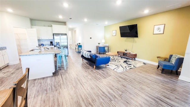 living room featuring sink and wood-type flooring