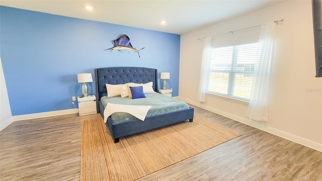 bedroom with hardwood / wood-style floors