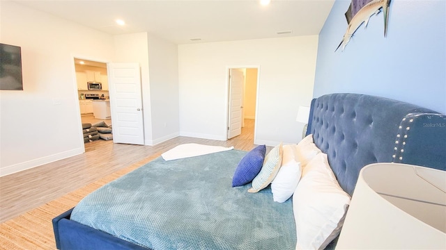 bedroom with light hardwood / wood-style floors