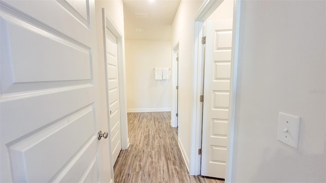 corridor with light wood-type flooring