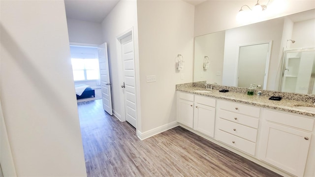 bathroom featuring hardwood / wood-style flooring and double sink vanity