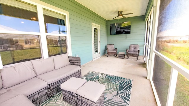 sunroom / solarium featuring ceiling fan