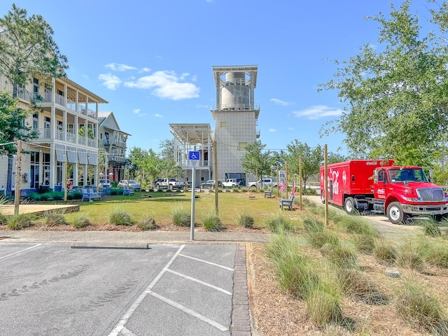 view of vehicle parking with a lawn