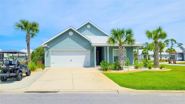 view of front of property with a front yard and a garage