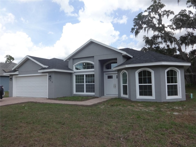 view of front of home with a garage and a front lawn