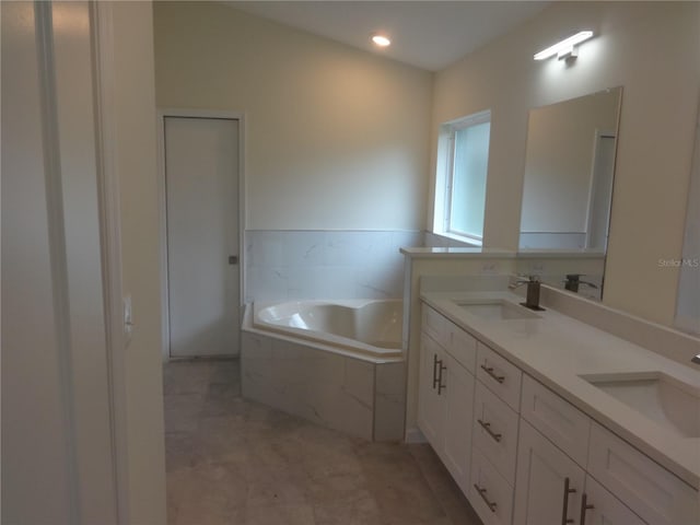 bathroom featuring dual sinks, tile flooring, tiled bath, and large vanity