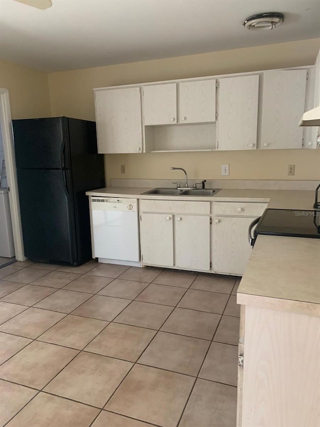 kitchen featuring black refrigerator, sink, white dishwasher, and light tile floors